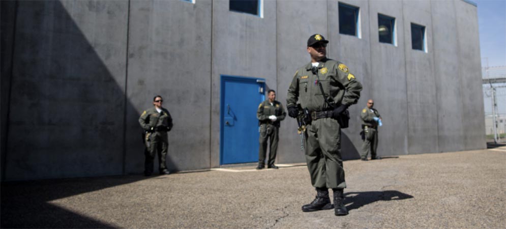 Four correctional officers standing outside